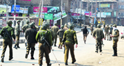 Securitymen disperse protesters in Srinagar on Tuesday. Tribune photo: Amin War