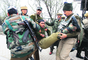 Securitymen carry the injured to a hospital in Srinagars Bemina on Wednesday. 