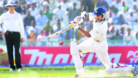 Shikhar Dhawan plays a shot during the third Test against Australia in Mohali on Saturday. He scored an unbeaten 185 off 168 balls. India were 283 without loss at stumps on Day 3. Tribune photo: Pradeep Tewari
