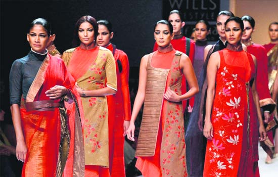Give me red: Models display creations of designer Kiran Uttam Ghosh at the Wills Lifestyle India Fashion Week in New Delhi. — PTI