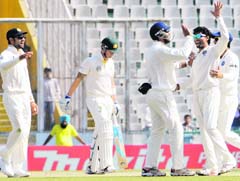 Team India celebrates after the dismissal of Michael Clarke in the third Test in Mohali on Monday. India clinched the series with a nerve-wracking six-wicket victory, taking an unassailable 3-0 lead.