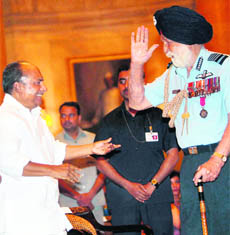 IAF Marshal Arjan Singh salutes Defence Minister AK Antony at the Defence Investiture Ceremony at Rashtrapati Bhavan in New Delhi on Saturday.