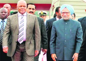 PM Manmohan Singh with South African Minister of Justice Jeffrey Thamsanqa Radebe on his arrival in Durban on Monday