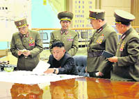 N Koreas Kim Jong-Un talks to his top generals on Friday.