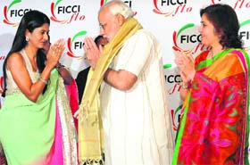 Gujarat CM Narendra Modi with FICCI Ladies Organisation office- bearers during its 29th annual session in New Delhi on Monday