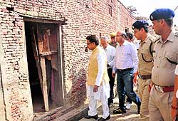 Chairman of the National Commission for Scheduled Castes PL Punia takes a view of ransacked houses at Pabnawa village in Kaithal district on Tuesday