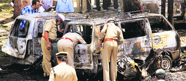 Police looks for clues at the blast site near the BJP office at Malleswaram in Bangalore on Wednesday.