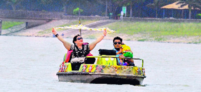 A family enjoys windy weather at Sukhna Lake in Chandigarh on Friday.