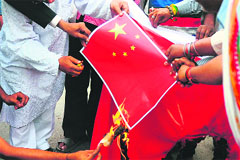 VHP activists burn a Chinese flag as they protest against the countrys intrusion into Indian territory, in Allahabad on Friday.