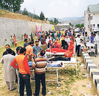 Patients outside sub-district hospital at Bhaderwah after the quake on Wednesday.