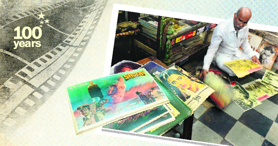 Indian cinema memorabilia dealer Shahid Mansoori sifts through posters for an order at his shop 'Mini Market' in Mumbai