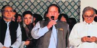 PML-N chief Nawaz Sharif (C) addresses supporters as his brother Shahbaz (R) and daughter Maryam (second from left) listen in Lahore on Saturday