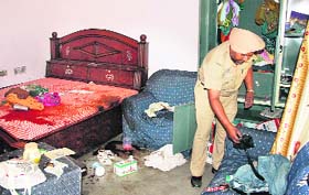 A policeman inspects the crime scene at the house of Ajit Singh in Mothanwala village on Monday