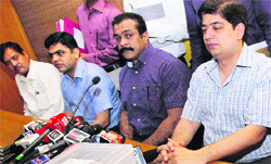 Mumbai police officials with confiscated laptops and other articles from S Sreesanths room in Mumbai on Saturday.