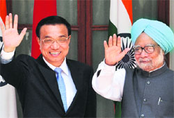 Chinese Premier Li Keqiang and Prime Minister Manmohan Singh wave prior to a meeting in New Delhi on Monday.
