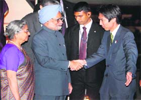 PM Manmohan Singh and his wife Gursharan Kaur are received by Japans Parliamentary Vice-Minister for Foreign Affairs Minoru Kiuchi upon their arrival in Tokyo on Monday
