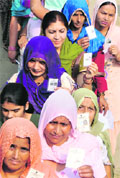 Women cast their votes at ward no. 6 at Kambopura village of Karnal on Sunday. Tribune photo: Ravi Kumar
