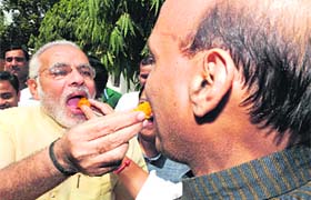 BJP president Rajnath Singh & Gujarat CM Narendra Modi celebrate the partys success