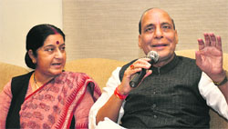 BJP chief Rajnath Singh addresses the media with party leader Sushma Swaraj in New Delhi.