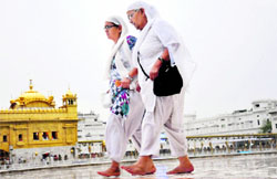 Rain greets devotees at the Golden Temple on Tuesday.