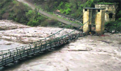 The overflowing Mandakini damages a bridge across the river in Kedarnath Valley of Uttarakhand on Monday.  PTI