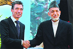 Afghan President Hamid Karzai (R) with NATO Secretary-General Anders Fogh Rasmussen after the security handover ceremony in Kabul on Tuesday