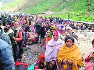 Pilgrims await evacuation in a flood-hit area. 