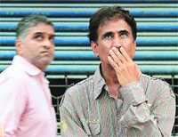 Onlookers react to falling Sensex outside the BSE on Thursday. 