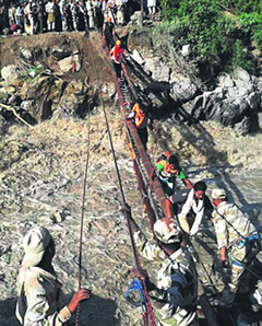 ITBP personnel rescue pilgrims at Gauri Kund on Friday.