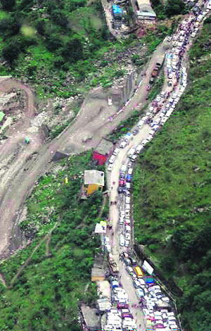 An aerial view of pilgrims’ vehicles stranded along a river owing to damaged roads.