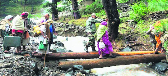 Army personnel rescue pilgrims in a flood-hit area in Chamoli.