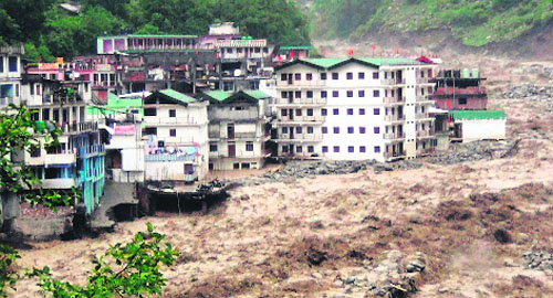A view of buildings in the Govindghat area partly submerged in the flooded Alaknanda river in Chamoli district.