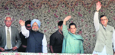 Prime Minister Manmohan Singh, UPA chairperson Sonia Gandhi and Jammu & Kashmir CM Omar Abdullah wave to locals and party workers at Kishtwar on Tuesday. On the extreme left is J-K Governor NN Vohra. 