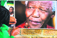 Pictures of Nelson Mandela at a mass prayer meeting in Cape Town on Thursday.  AFP