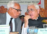 Foreign Minister Salman Khurshid talks to J&K Governor NN Vohra at a conference in Srinagar on Saturday.