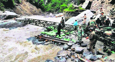 Border Roads Organisation and Army personnel construct a bridge over the Alaknanda at Lambagar in Uttarakhand.