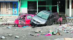 Wrecked vehicles lie in front of damaged houses in Sonprayag in Uttarakhand on Tuesday.