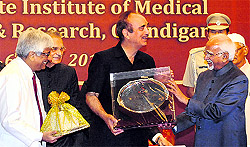 Vice-President Hamid Ansari (R) being honoured by Union Minister for Health and Family Welfare Ghulam Nabi Azad (C) at the 51st foundation day of the PGIMER, Chandigarh, on Saturday. Prof Yogesh Chawla, Director, PGI, is at the extreme left