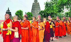 Buddhist monks take out a candlelight march at the Mahabodhi Temple in Bodh Gaya on Tuesday