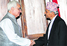 Indian External Affairs Minister Salman Khurshid (L) with Nepalese Chairman of the Interim Council of Ministers, Khil Raj Regmi, in Kathmandu on Tuesday