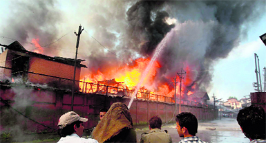 Firefighters try to douse rising flames at the secretariat in Srinagar on Thursday.