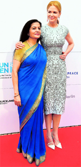 Actress Nicole Kidman (R) and Deputy Executive Director of U.N. Women Lakshmi Puri pose on the red carpet as they arrive for a reception of Cinema for Peace in Berlin.