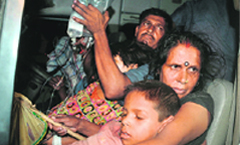 Parents rush their ill children to the Patna Medical College & Hospital on Wednesday.  PTI