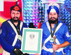 Kawaljit Singh and Gurinder Singh show their Guinness certificate. 