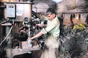 A labourer at a foundry in Goraya. Many units have shifted to Uttar Pradesh and Haryana