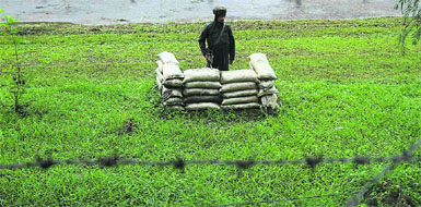 A soldier stands guard close to the Line of Control in Poonch district. 
