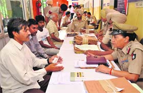Residents enquire about the status of their complaints at the Sector 34 police station in Chandigarh on Saturday