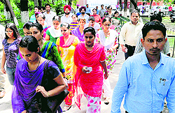 Candidates come out of the examination centre after appearing in the Cooperative Bank examination at Government Model Senior Secondary School in Sector 46, Chandigarh, on Sunday