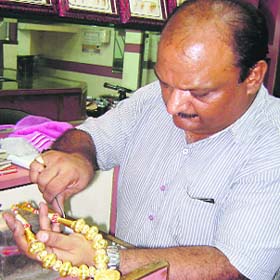 A jeweller gives final touches to a Kaintha at Mandi Ahmedgarh