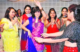 Women dance at a kitty party